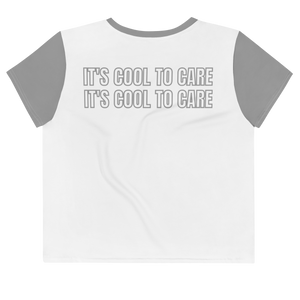 White cropped short sleeve t-shirt with contrast grey neckline and sleeves, and grey "IT'S COOL TO CARE" large text repeated twice at back.