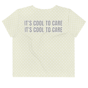 Beige short-sleeve cropped t-shirt with white mini polka dot heart print & large grey "IT'S COOL TO CARE" text across back