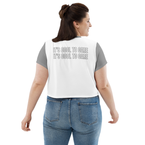 Plus-size model in white cropped tee with grey sleeves, neckline, and "IT'S COOL TO CARE" large text at back.